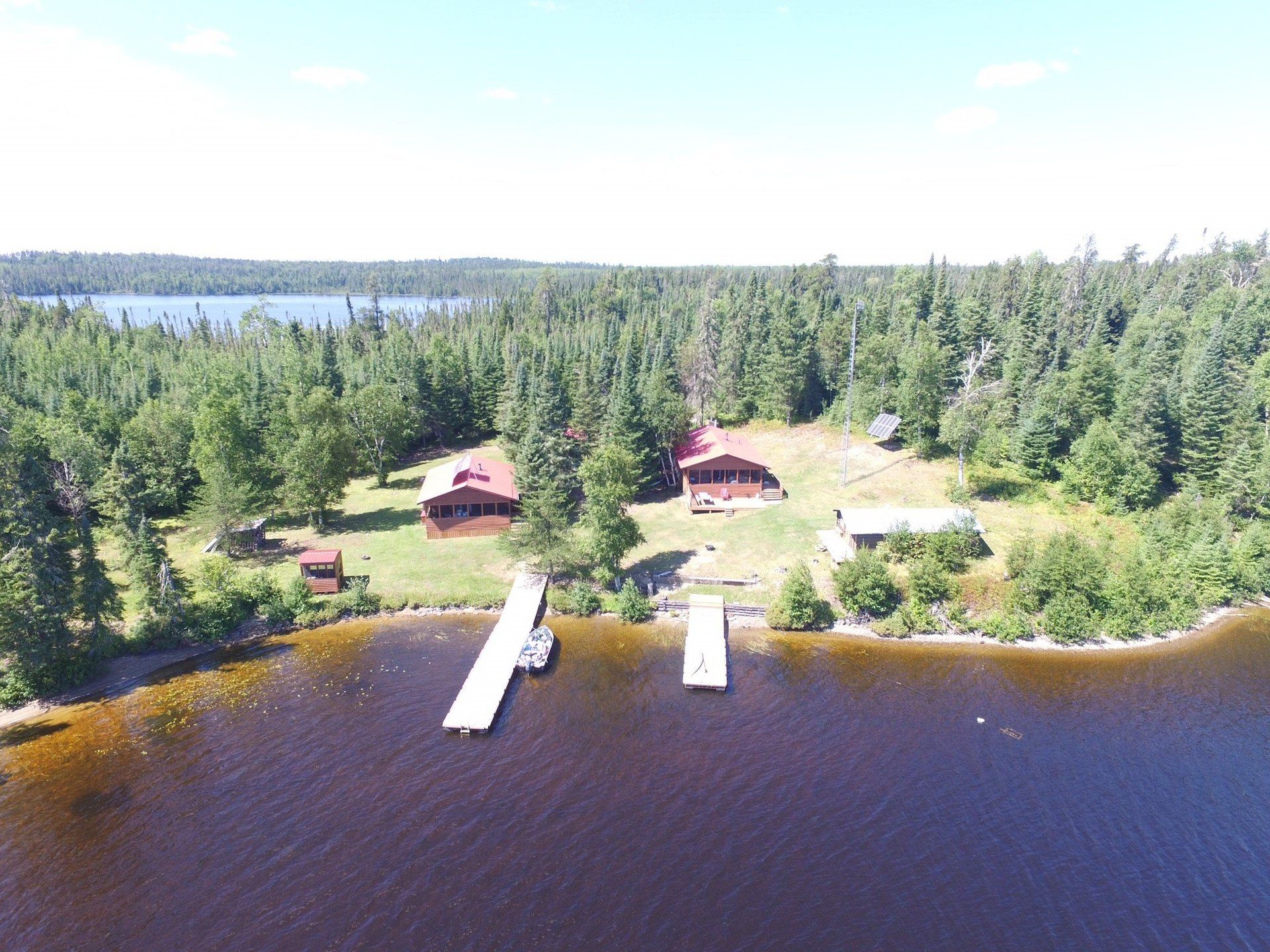 An aerial view of a lodge on a lake