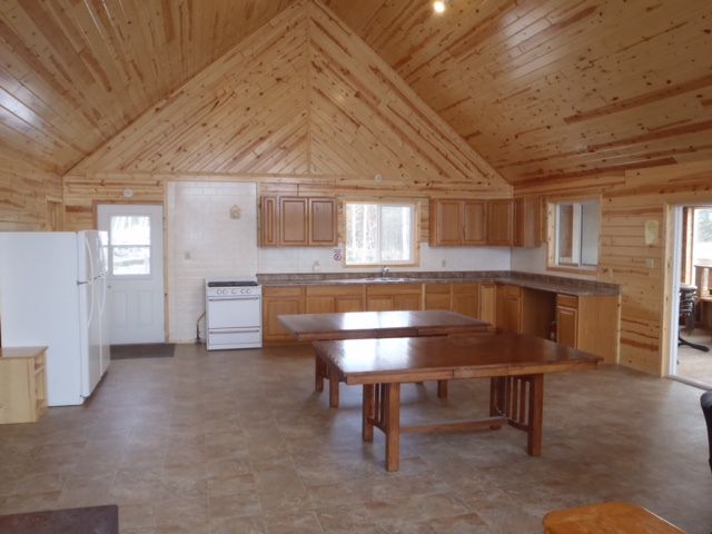 A kitchen with wooden cabinets and a vaulted ceiling