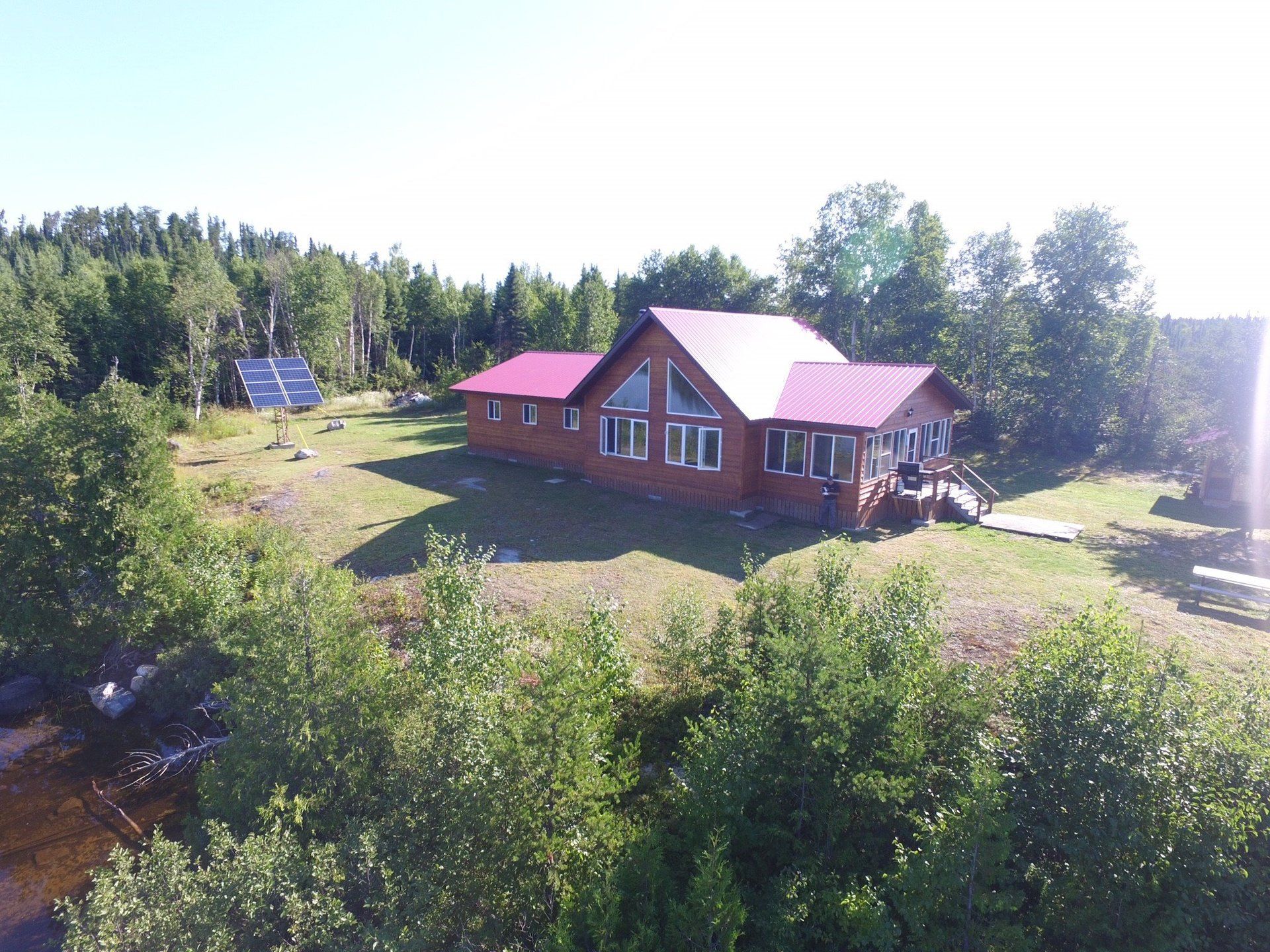 An aerial view of a house with a red roof