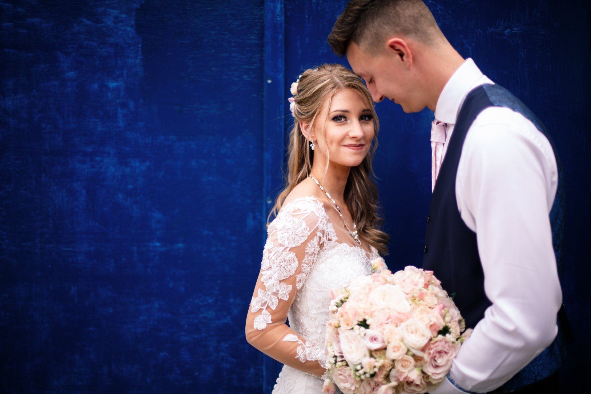 Cornwall wedding bride and groom with blue background