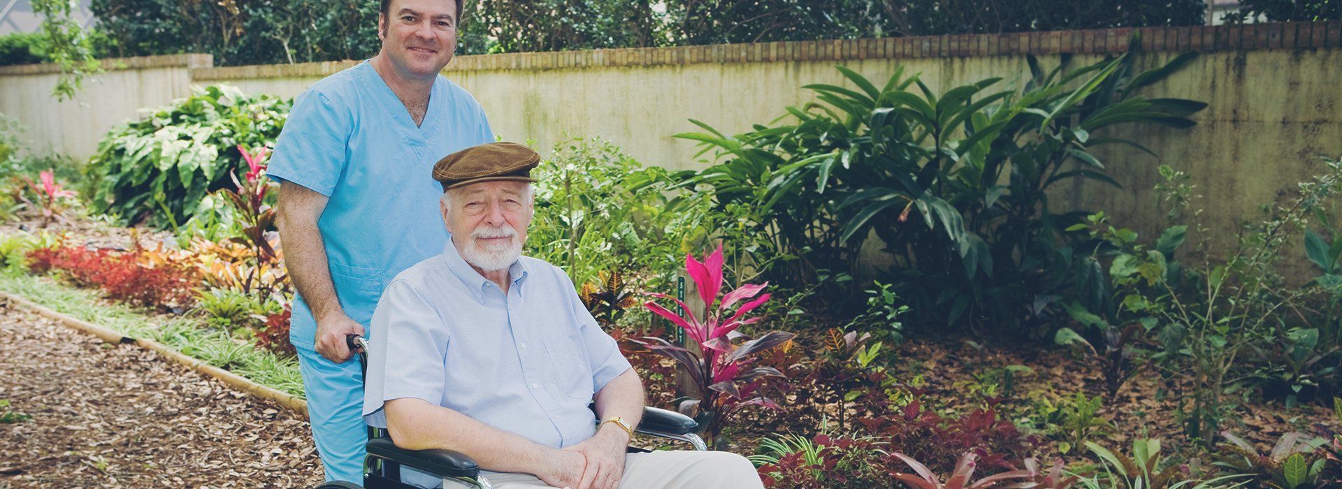 A carer assisting the elderly man