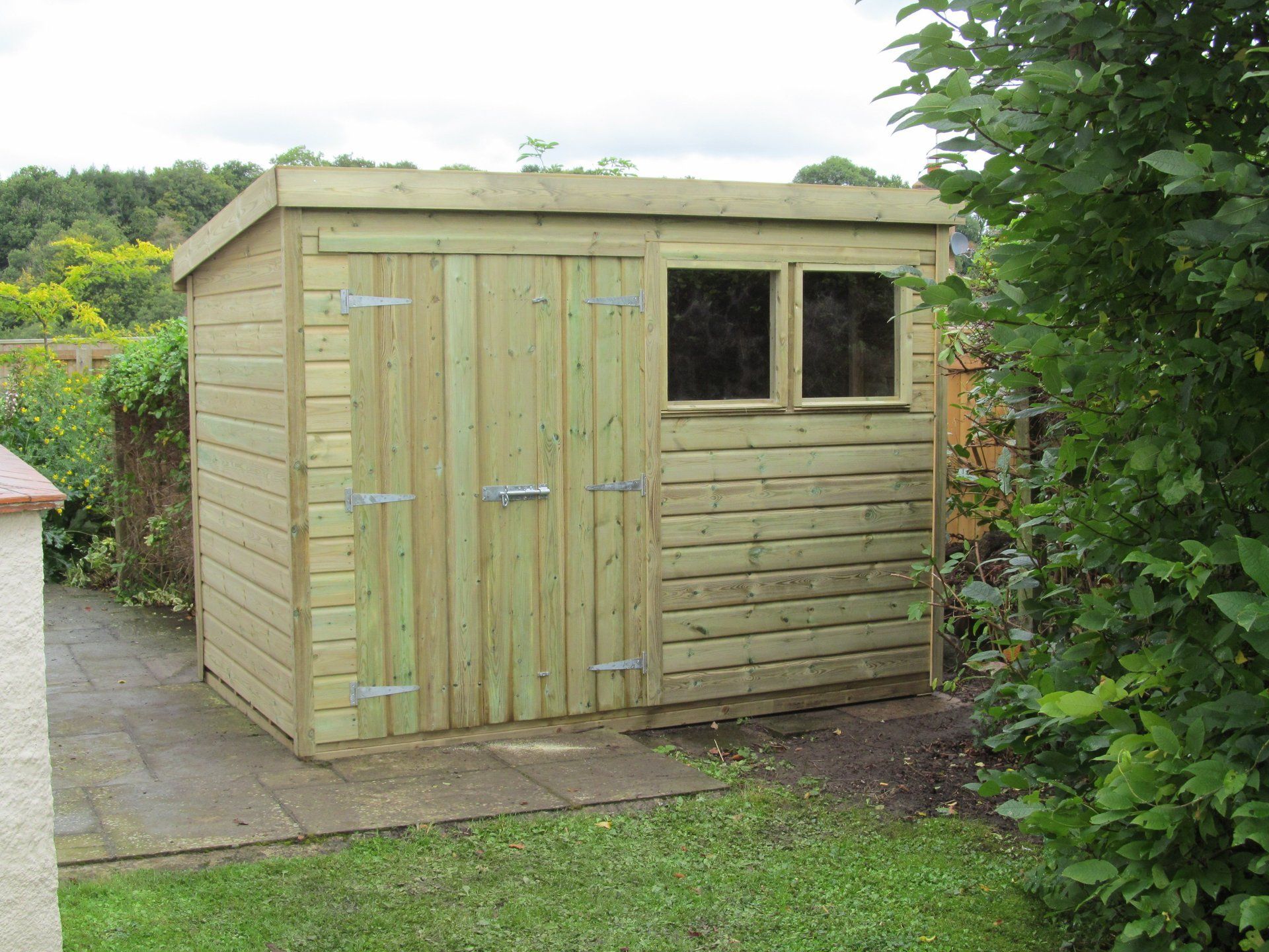 Workshop shed with sloping roof large doors and double windows