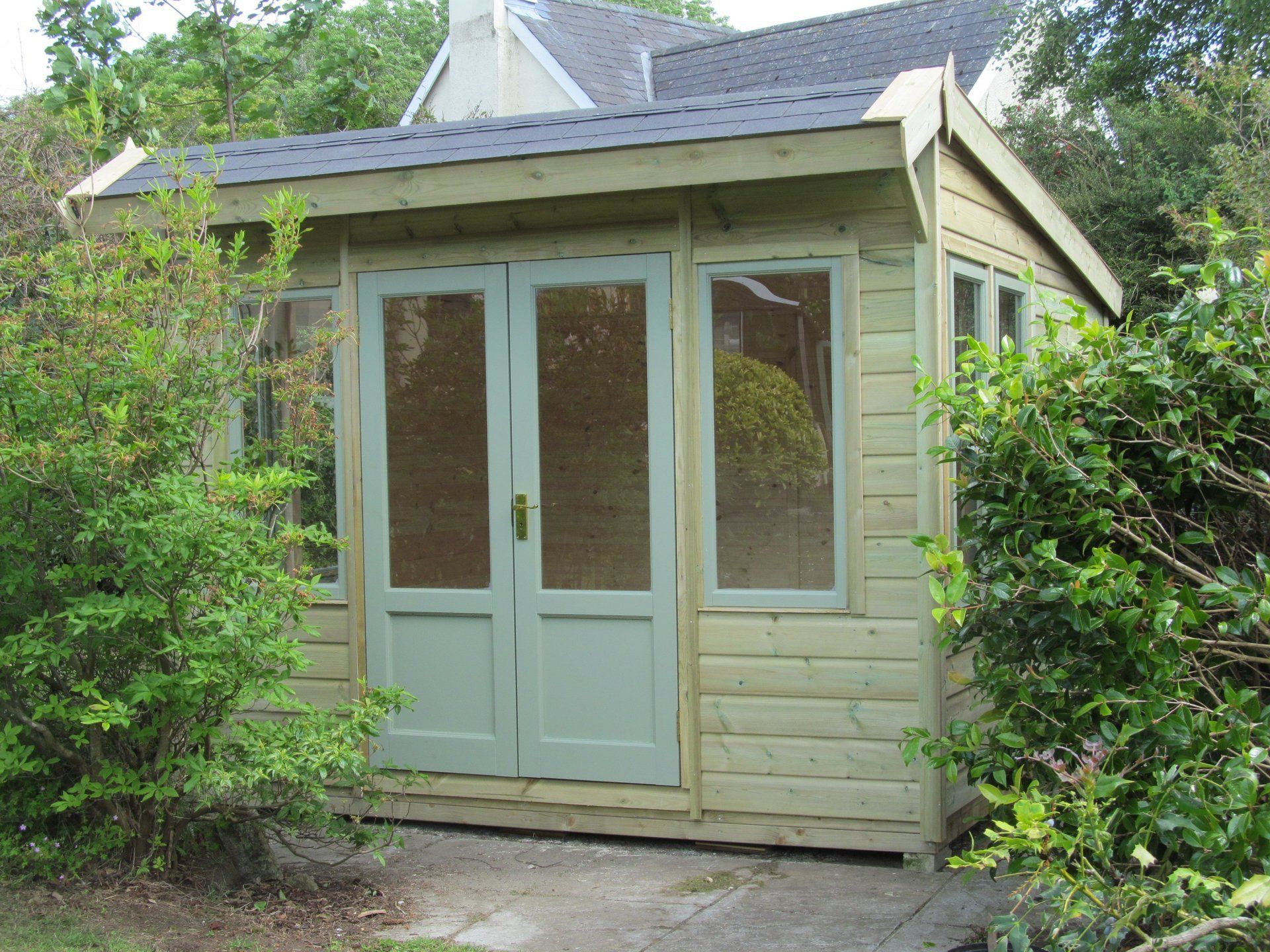 The Ashton Summerhouse with painted doors and windows by CP Sheds Devon