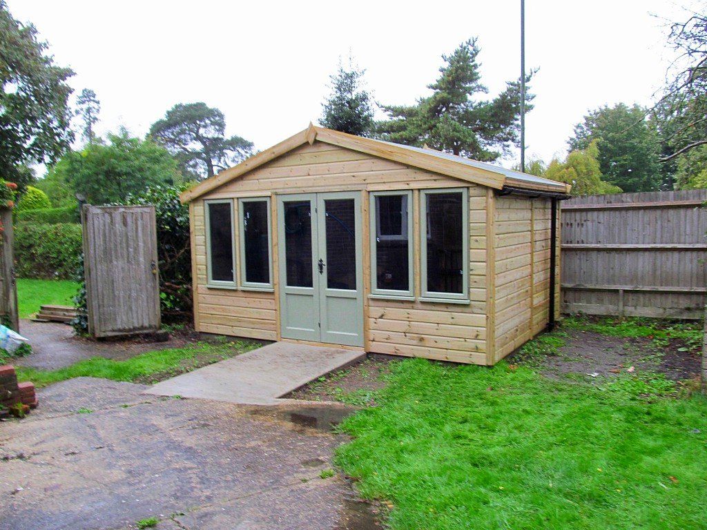 A perfect garden office with painted double doors and two double windows