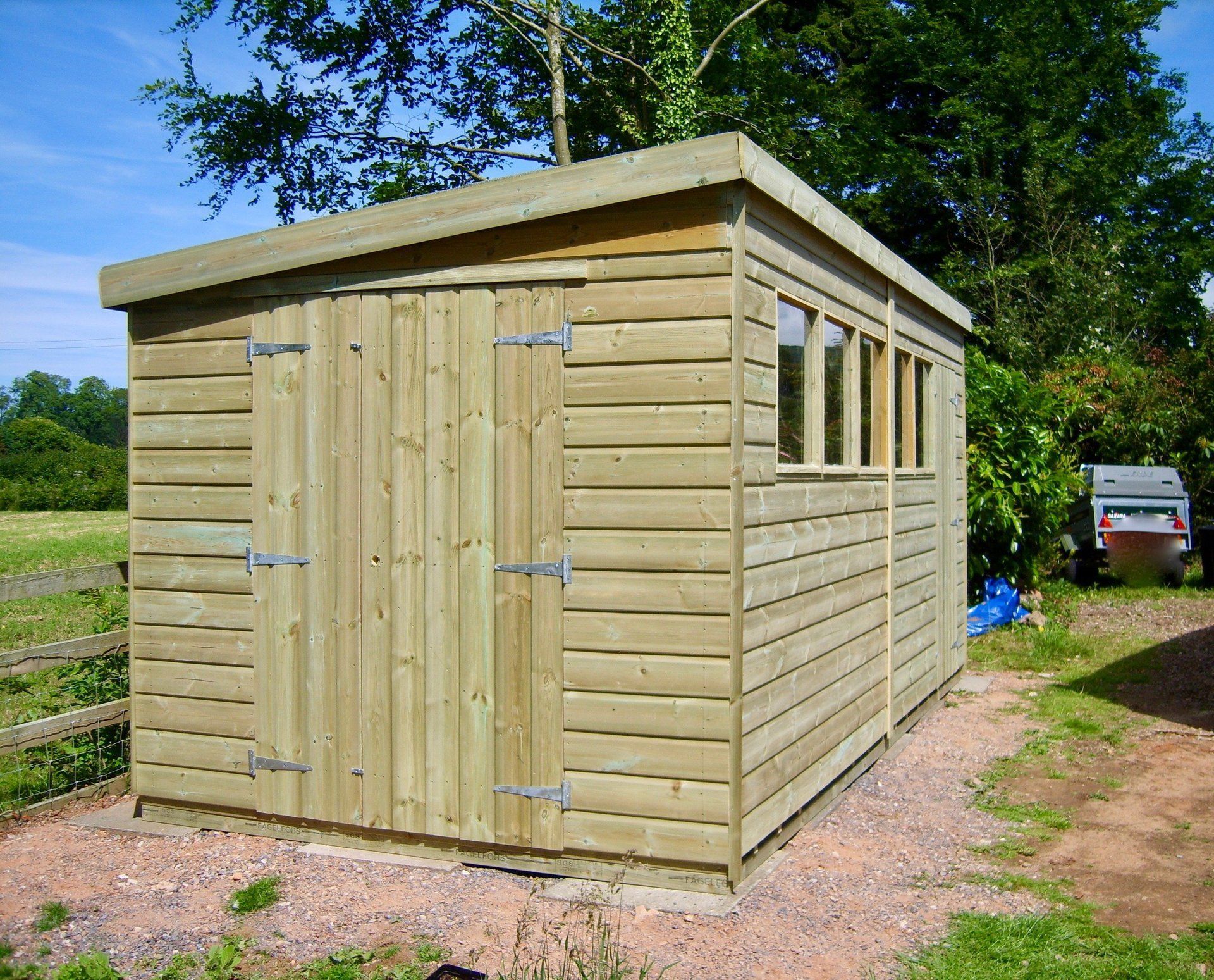 Large Workshop Shed with sloping roof door to front and four windows to the side