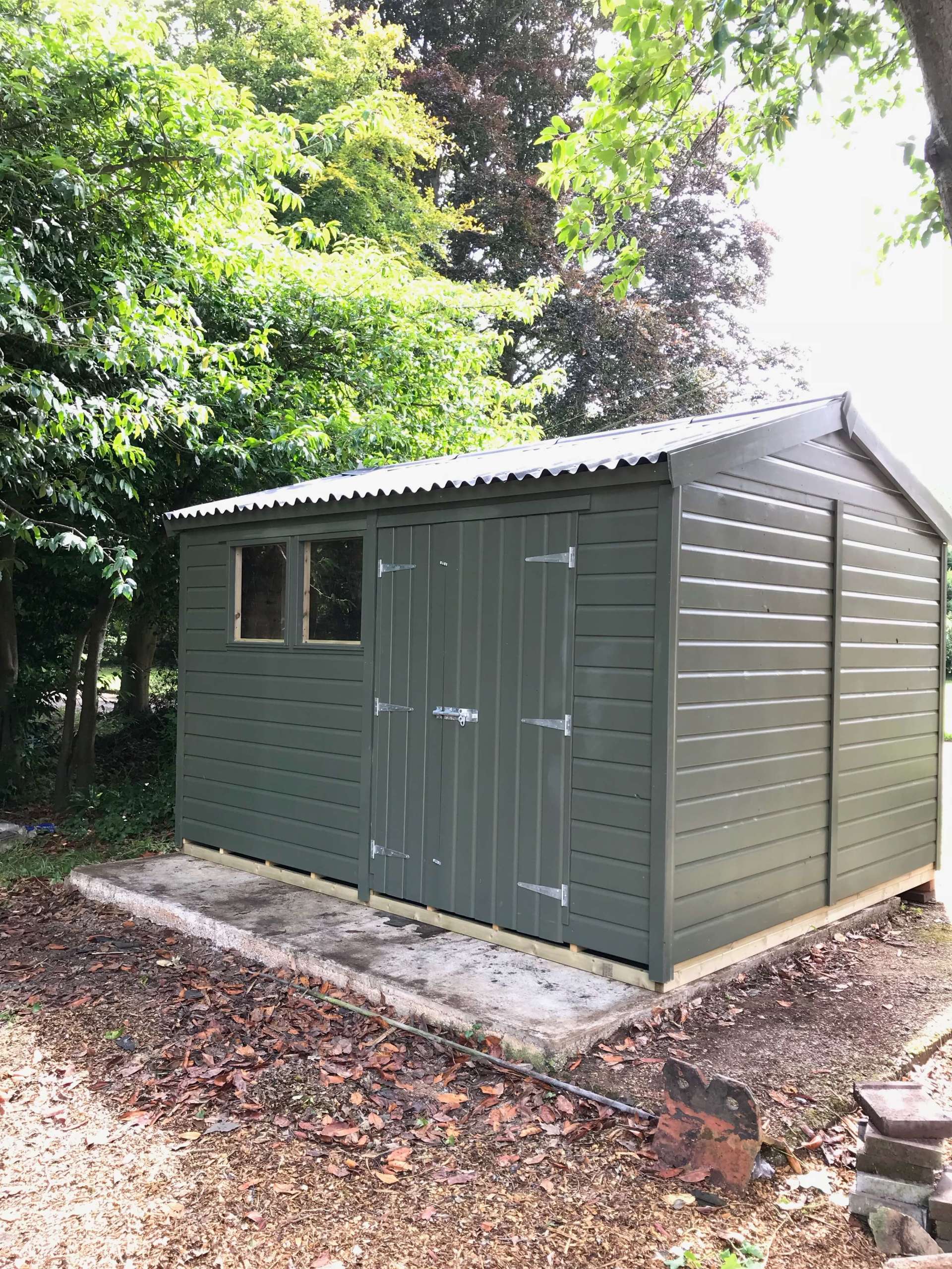 Large painted workshop shed with doors to front and side