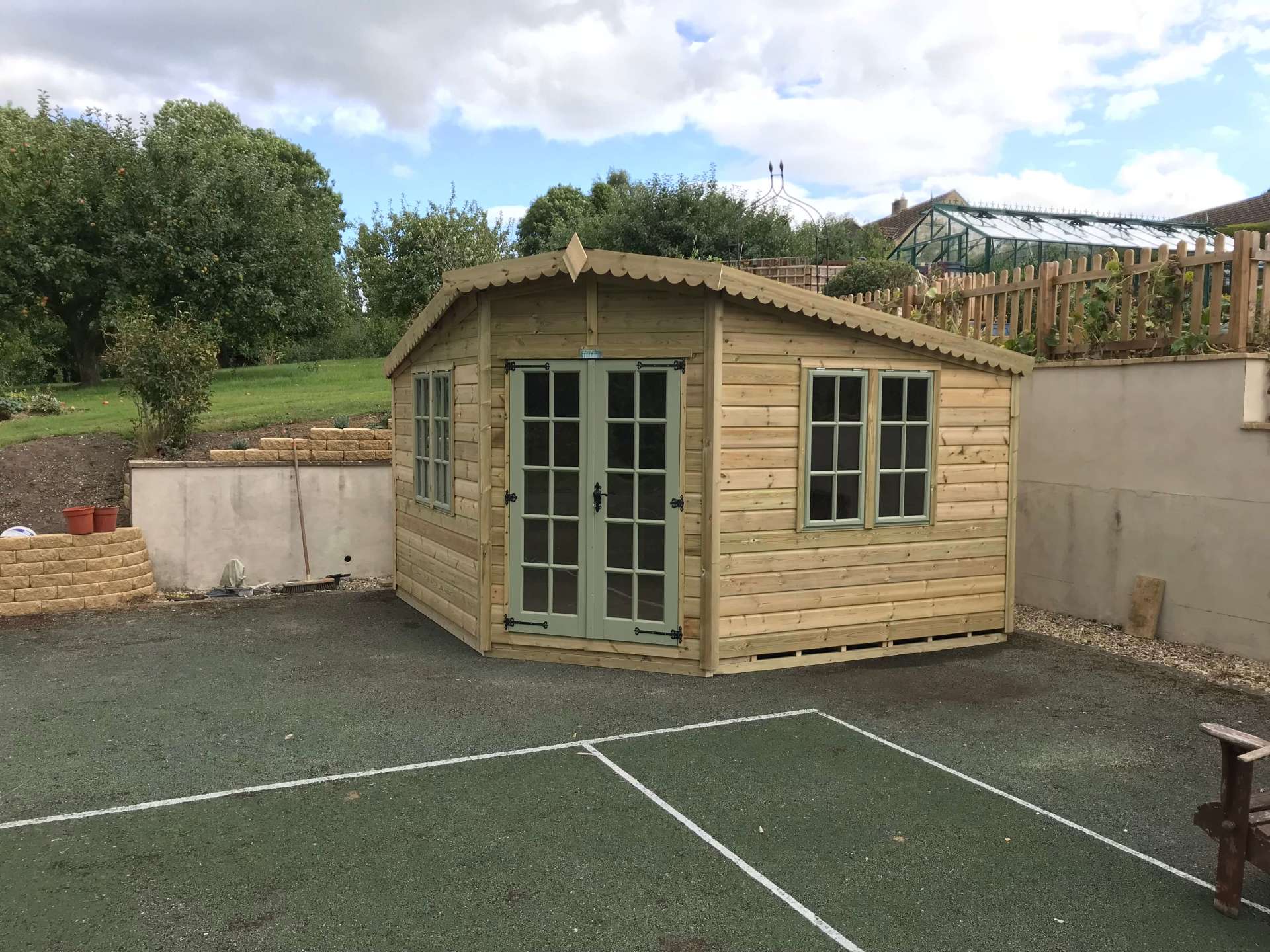 Corner Summer House from CP Sheds of Devon with painted doors and windows