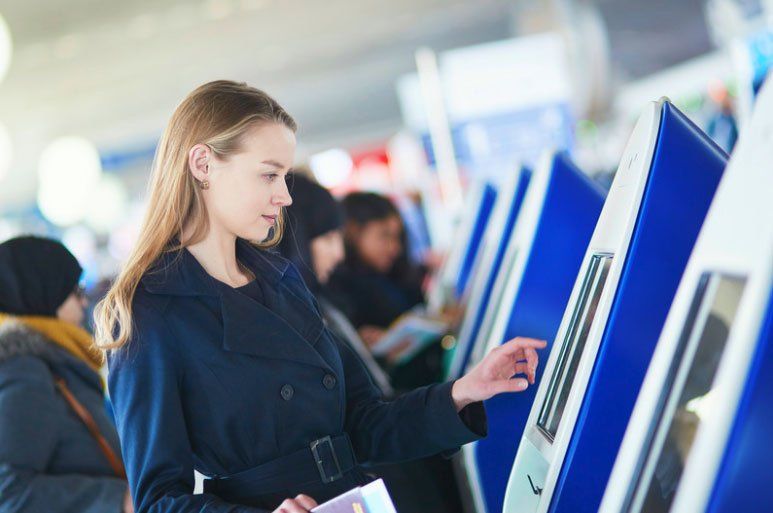 Woman interacting with a self service kiosk