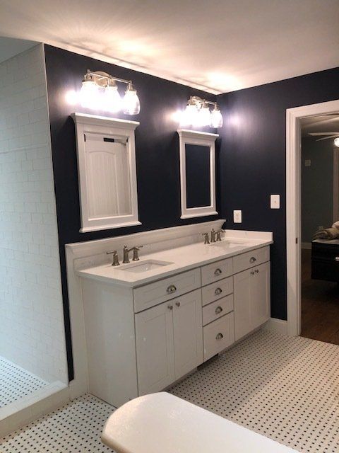 A bathroom with two sinks and two mirrors