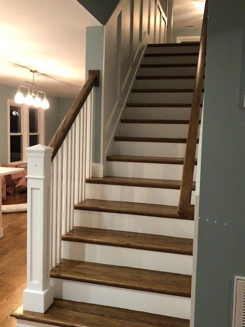 A staircase with wooden steps and a white railing