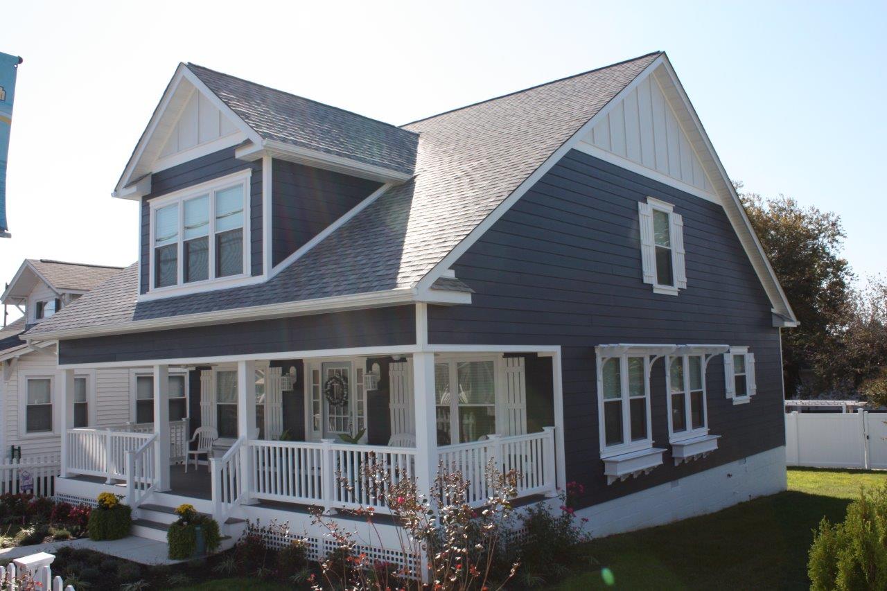 A large house with a large porch and a white trim