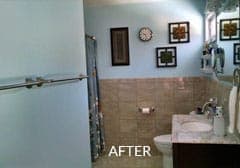 After view of a  bathroom with a sink , toilet , shower and mirror.