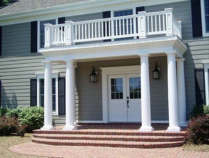 A large house with a balcony and columns
