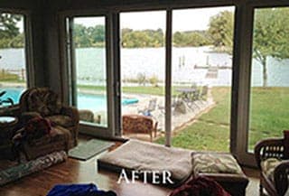 A living room with sliding glass doors and a view of a river.