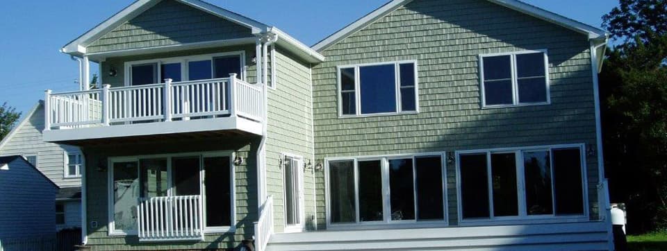 Two houses are sitting next to each other on a sunny day.