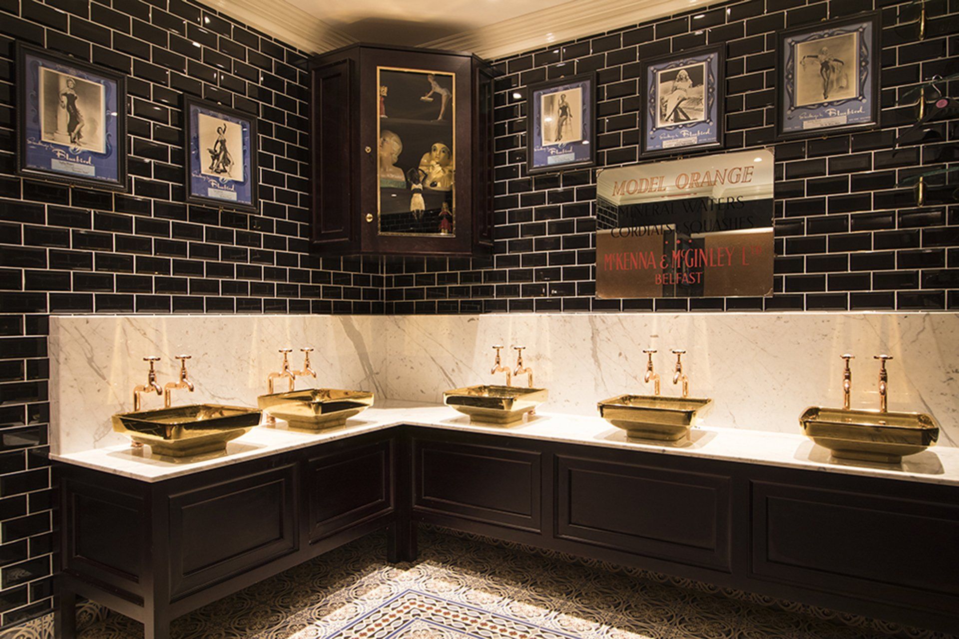 Harp Bar hand washing area, featuring the gold sinks