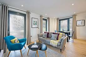 living room, gray sofa and mixed pink&gray cushion, and blue chair