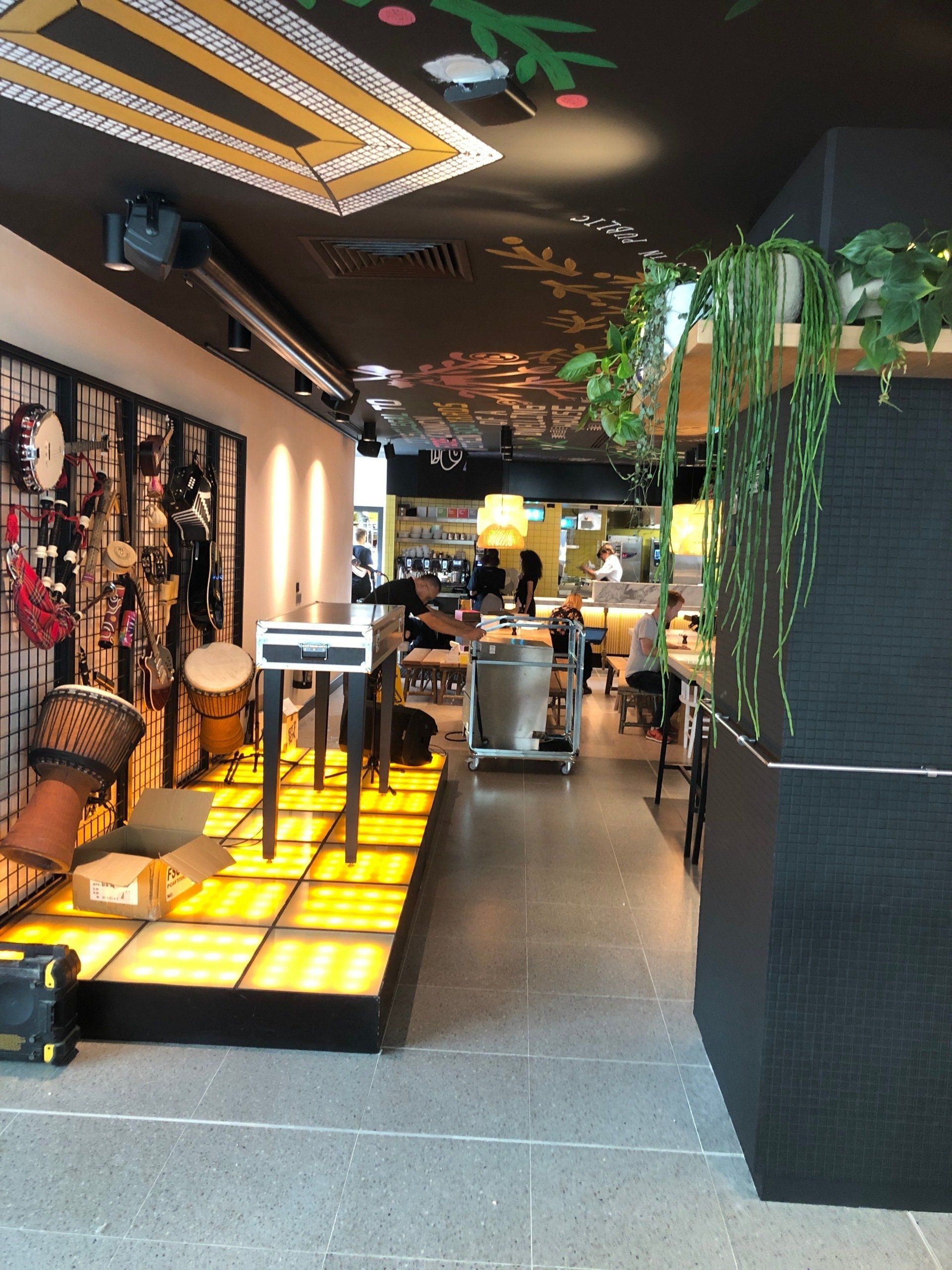 mini stage with instrumental background and yellow lighting floor
