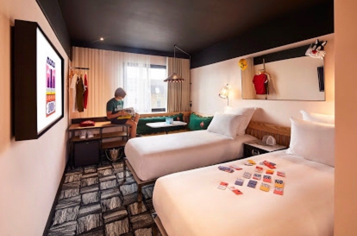 bedroom for 2 single beds and a girl reading a book