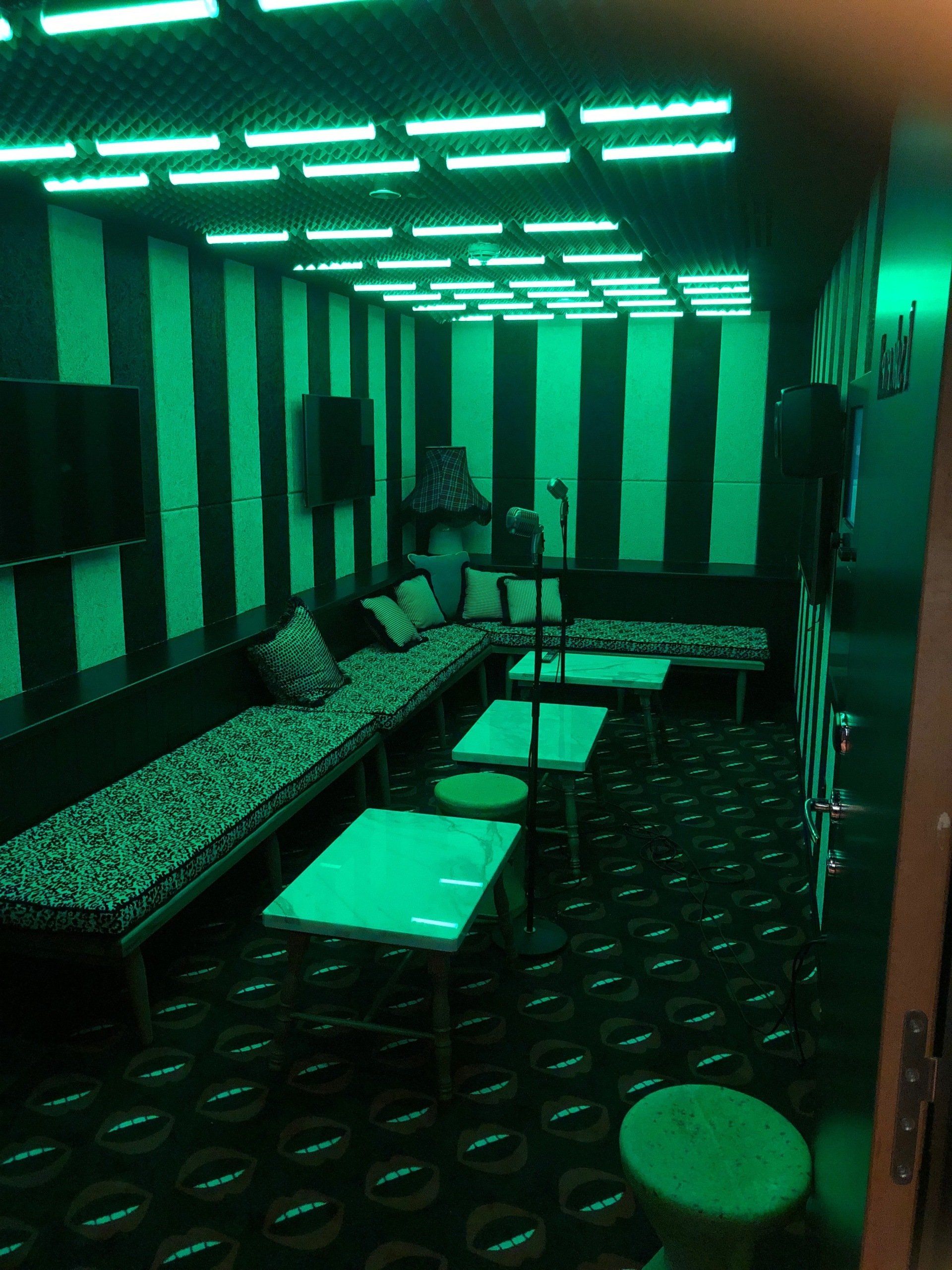 private room for karaoke with green lighting