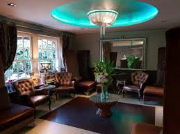 waiting area or living room with blue lighting, centre table and flower vase with flower