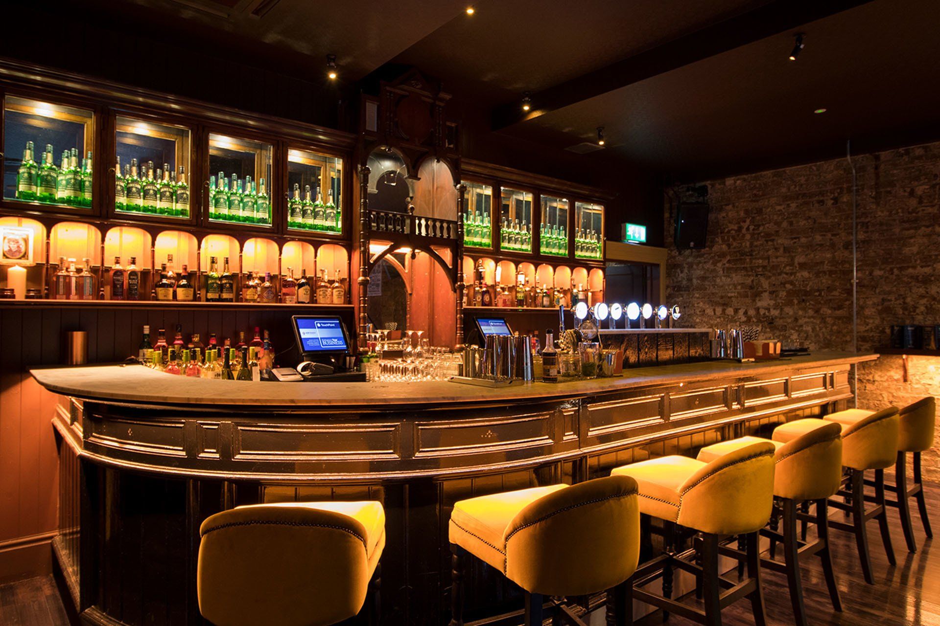 Pug Ugly’s bar service area and yellow chairs