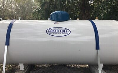 Man closes a knob on a propane tank — Fuel Company in Sebring, FL Man closes a knob on a propane tank — Fuel Company in Sebring, FL