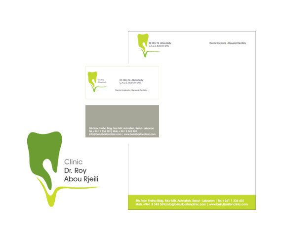 A set of business cards and a letterhead for a dentist