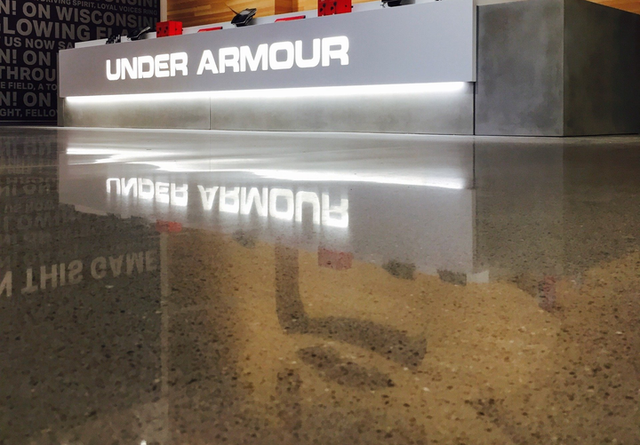 A under armour store with a reflection in the floor