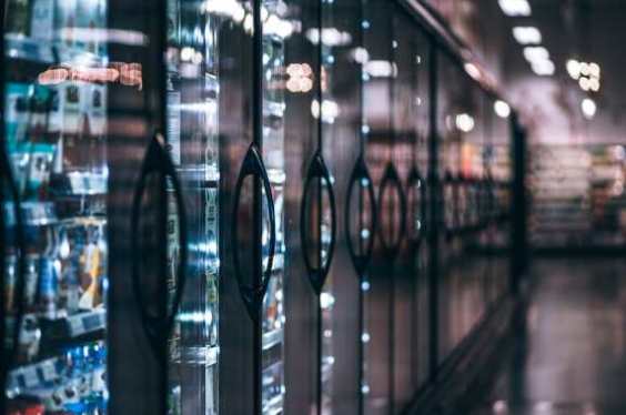 A row of refrigerators in a grocery store.