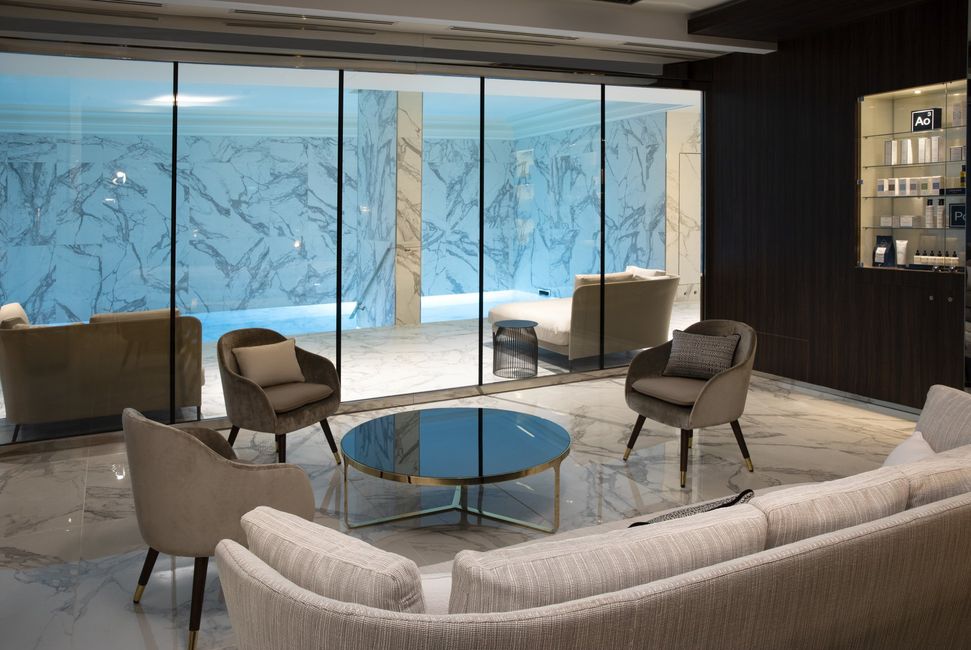 Un salon avec un canapé, des chaises et une table basse.