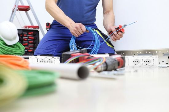 Man Cutting Cable Wire — Newport, NC — Plisko Service Solutions Man Cutting Cable Wire — Newport, NC — Plisko Service Solutions