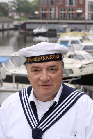 A person wearing a white sailor hat with 