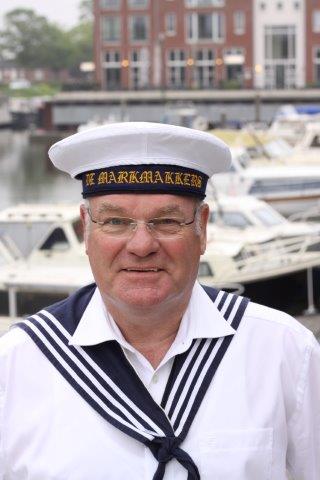 A person wearing a white sailor hat with 