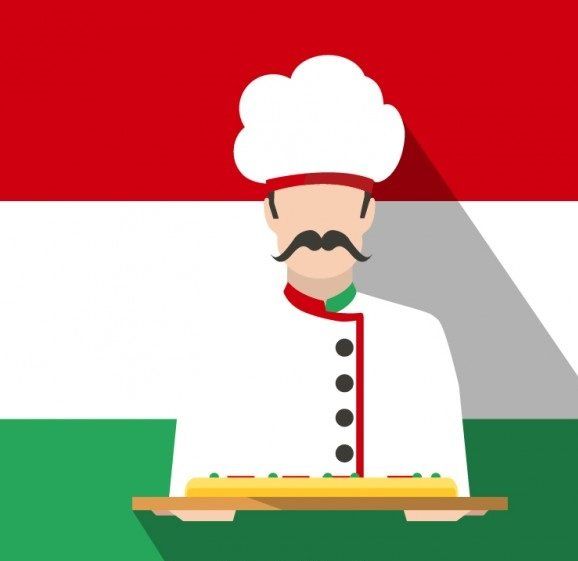 Een chef-kok houdt een gerecht vast, voor de Hongaarse vlag.