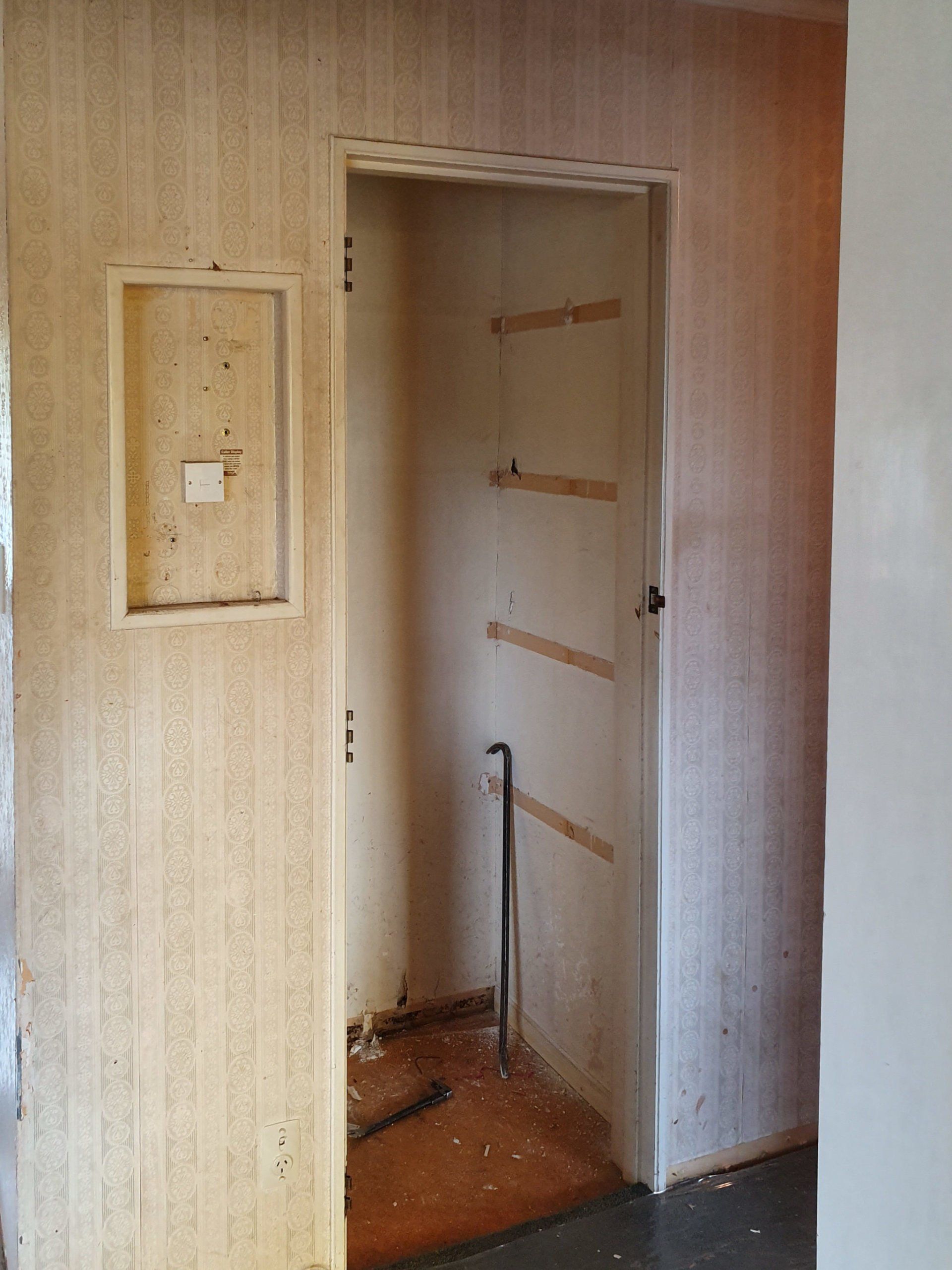 A room with a door and a cane in it