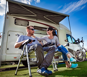 Couple enjoys the outdoors with an RV they stored at Lake Road Storage