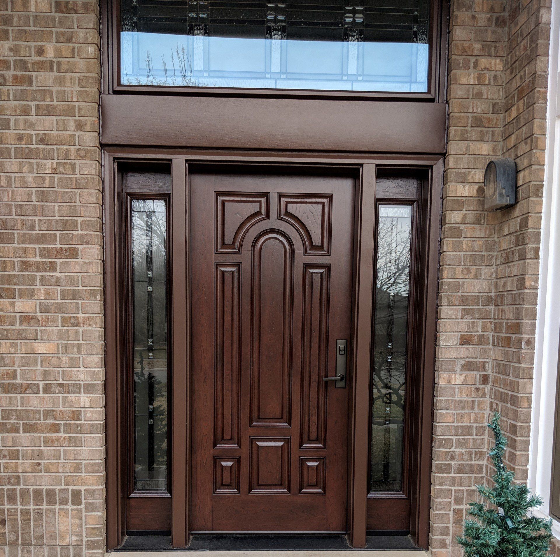A brick building with a wooden door and a window