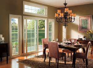 A dining room with a table and chairs and a chandelier.