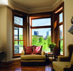 A living room with a large window and a chair