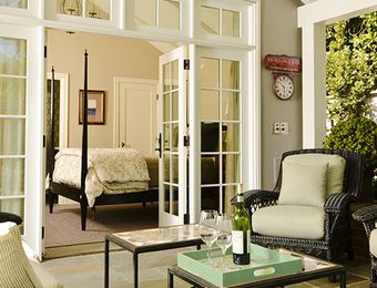 A living room with a bottle of wine on a table