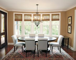 A dining room with a table and chairs and a chandelier