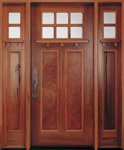 A wooden door with three windows and a handle.