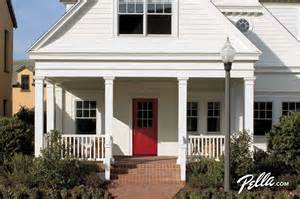 A white house with a red door and porch