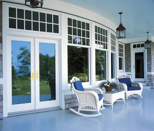 A porch with rocking chairs and a coffee table