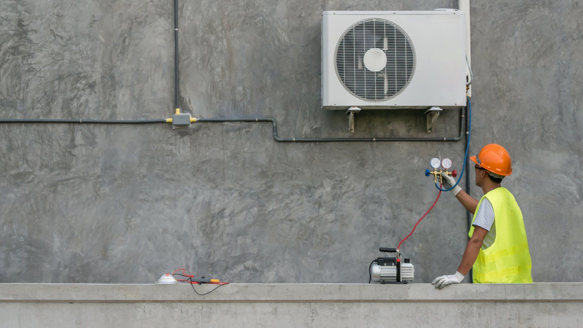 Technician looking at AC unit