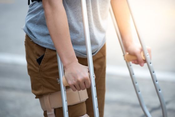 Disabled Woman With Crutches Or Knee Support — Camarillo, CA — Merlin Medical Supply Disabled Woman With Crutches Or Knee Support — Camarillo, CA — Merlin Medical Supply