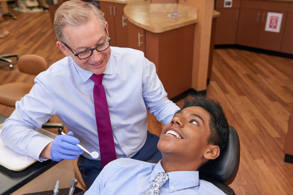 Photo of Dr. Boggan with a male teenage patient