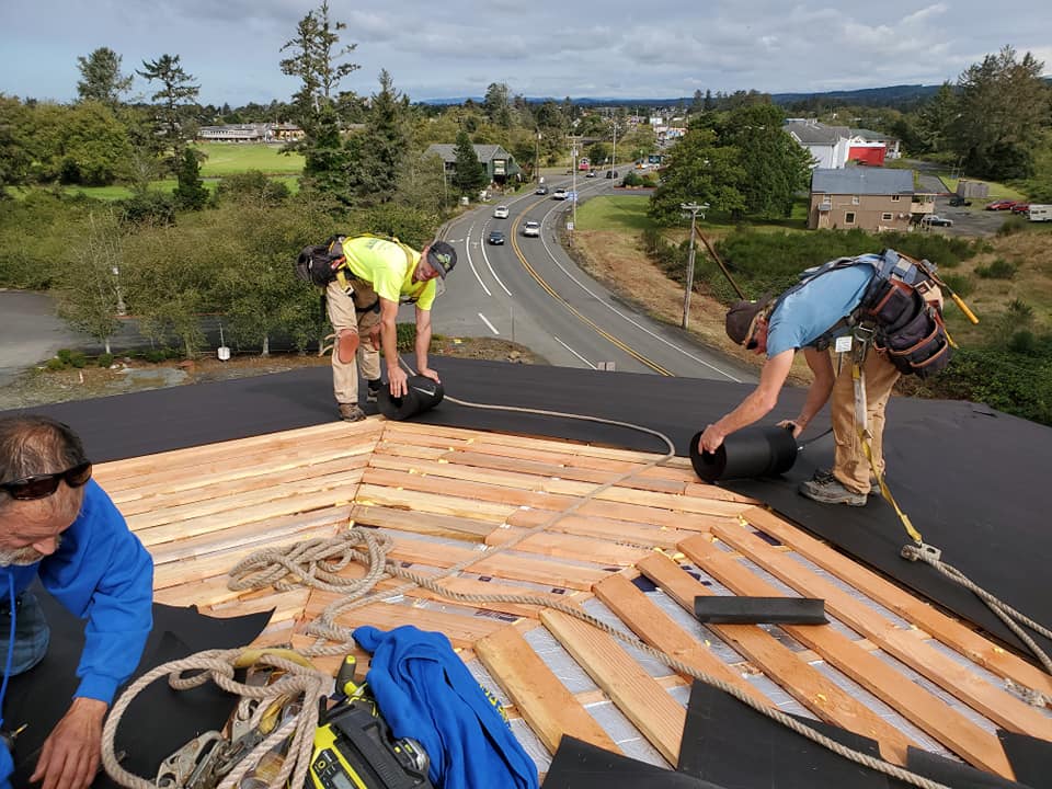 Group of People Repairing the Roof — Astoria, OR — Northwest Roofing & Construction LLC