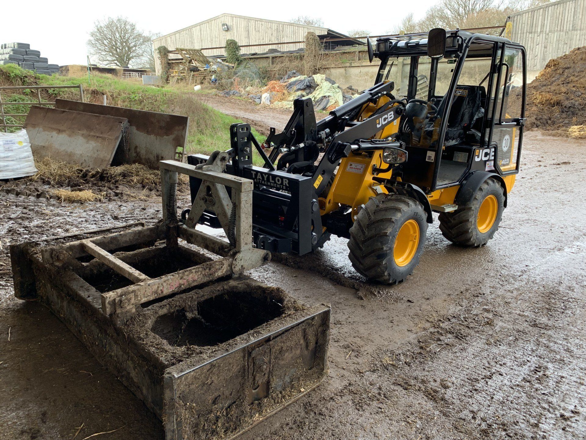 Floating Yard Scraper Headstock Attachment in use on JCB Loader